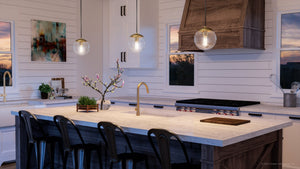 A kitchen with a large island featuring the unique Urban Ambiance UHP4017 Minimalist Pendant 12.5''H x 12''W, Brushed Bronze Finish, Canton Collection.