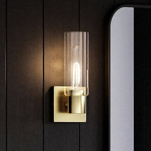 A unique and gorgeous UHP4055 Cosmopolitan Wall Sconce with a glass shade and a mirror.