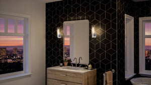 A luxurious bathroom with a UHP4056 Cosmopolitan Wall Sconce 12.625''H x 5''W, Polished Chrome Finish from the Tustin Collection by Urban Amb