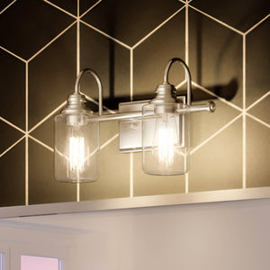 A beautiful Urban Ambiance bathroom with two UHP4061 Vintage Bath Light fixtures and a tiled wall.