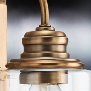 An UHP4065 Vintage Wall Sconce 9.875''H x 4.5''W from the Hedland Collection, with a unique Olde Brass Finish and a clear glass