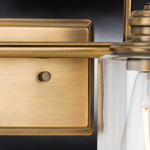 An Urban Ambiance bathroom light fixture with a clear glass bulb, the UHP4066 Vintage Bath Light 9.875''H x 14.625''W, Olde Brass Finish from