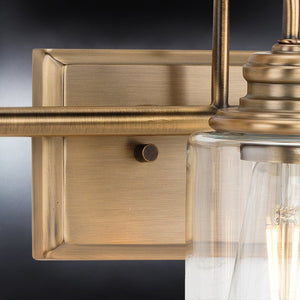 An Urban Ambiance bathroom light fixture with a luxurious UHP4067 Vintage Bath Light 9.875''H x 23.375''W, Olde Brass Finish, Hedland Collection glass