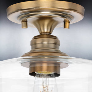 A beautiful lighting fixture with an Olde Brass Finish and clear glass bulb.