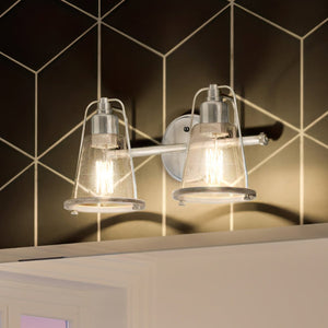 A beautiful bathroom with two UHP4071 Coastal Bath Lights 8.25''H x 15''W, Brushed Nickel Finish, Kempsey Collection by Urban Ambiance hanging above a tiled