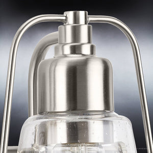 A unique UHP4071 Coastal Bath Light, featuring a gorgeous brushed nickel finish and clear glass shade from the Kempsey Collection by Urban Ambiance.