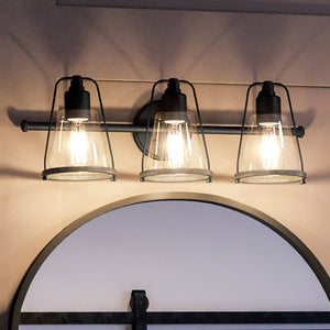 A beautiful Coastal Bath Light with a unique Midnight Black Finish, part of the luxurious Kempsey Collection, featuring three lights and a mirror.