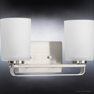 A gorgeous lighting fixture, the Urban Ambiance UHP4105 Modern Bath Light is a stunning lamp with a Brushed Nickel Finish and two white glass shades.