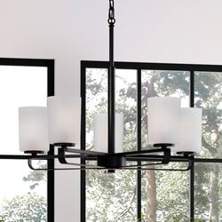 A beautiful Urban Ambiance UHP4108 Modern Chandelier lighting fixture hanging over a window in a living room.