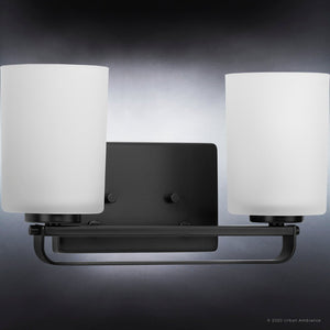 An Urban Ambiance bathroom lighting fixture with two white glass shades, the UHP4113 Modern Bath Light 7.625''H x 13.625''W from the Broome Collection and