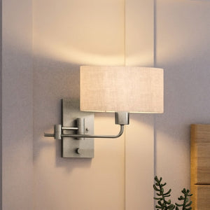 A luxury wall sconce with a unique white shade.