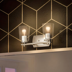 An Urban Ambiance bathroom with a gorgeous UHP4141 Traditional Bath Light 7.625''H x 13.875''W, Brushed Nickel Finish, Esperance Collection tiled wall
