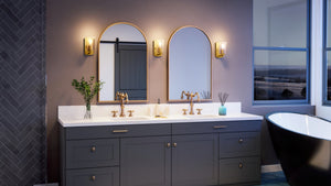 A bathroom with two sinks and a tub, featuring the unique UHP4145 Traditional Wall Sconce 7.75''H x 4.5''W lighting fixture with a Satin