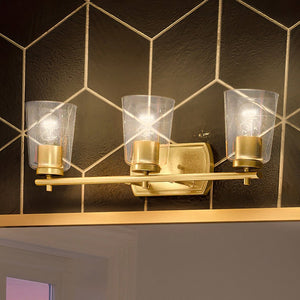 A gorgeous bathroom with a unique Urban Ambiance UHP4147 Traditional Bath Light 7.625''H x 23''W, Satin Gold Finish, Esperance Collection tiled wall.