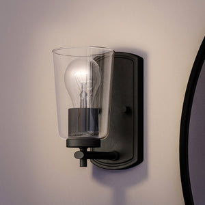 A unique and luxury wall sconce with a light bulb, part of the Esperance Collection.