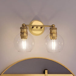An UHP4171 Vintage Bath Light 10.875''H x 15.5''W, Olde Brass Finish, Belfast Collection bathroom light with two glass globes by Urban Ambiance