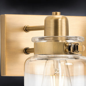 A beautiful UHP4191 Vintage Bath Light 8.625''H x 13.25''W, Olde Brass Finish, Bridgeport Collection wall sconce with a clear glass jar