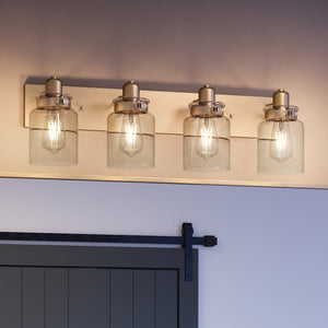 A bathroom with three UHP4193 Vintage Bath Light 8.625''H x 30.25''W, Olde Brass Finish, Bridgeport Collection lighting fixtures by Urban Ambiance and