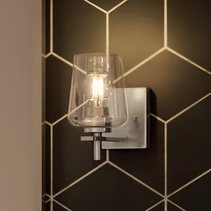 A gorgeous Urban Ambiance UHP4200 New Traditional Wall Sconce, a lighting fixture in a bathroom with a black and white tiled wall.