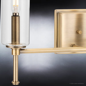 A contemporary luxury lighting fixture, the UHP4226 Parkes Collection wall sconce from Urban Ambiance features an Olde Brass finish and clear glass cylinder.