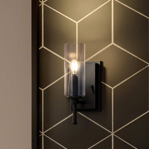A beautiful lighting fixture, the UHP4228 Contemporary Wall Sconce from the Parkes Collection by Urban Ambiance is a lamp with a geometric pattern on the wall.