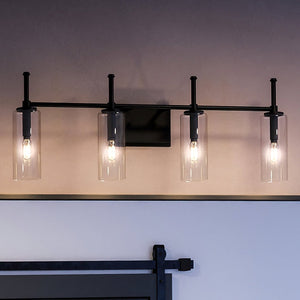 A bathroom with three unique lighting fixtures from the Parkes Collection and a barn door by Urban Ambiance.