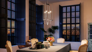 A luxurious dining room with a table and chairs featuring a gorgeous Urban Ambiance UHP4244 Contemporary Chandelier.