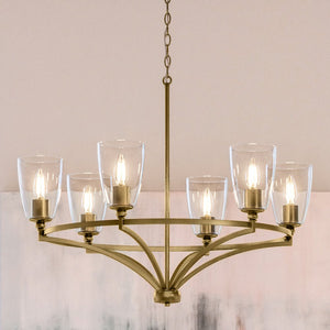 A gorgeous Traditional Chandelier 14''H x 30''W, with glass shades hanging in a room.