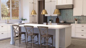 A luxury kitchen with a center island and stools featuring the stunning UHP4254 New Traditional Pendant 15.25''H x 17.875''W, Brushed Bronze Finish from