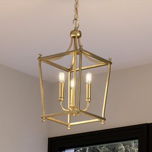A unique UHP4257 Traditional Chandelier, with a beautiful brushed bronze finish from the Coronado Collection by Urban Ambiance, hanging over a window in a living room.