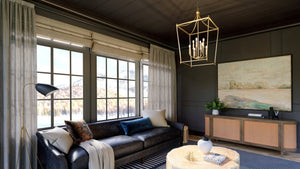 A living room with black walls and unique Urban Ambiance lighting fixtures.