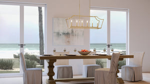 A beautiful dining room with a unique UHP4260 Tranditional Chandelier and chairs, with a view of the ocean.