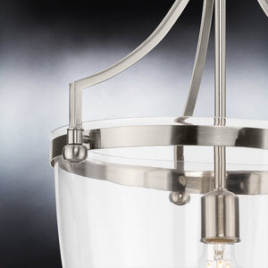 A beautiful Traditional Pendant lighting fixture with a clear glass shade.