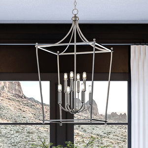 A luxurious living room with a beautiful UHP4270 Traditional Chandelier 36''H x 20''W, Brushed Nickel Finish, Coronado Collection hanging over a window by Urban Ambiance