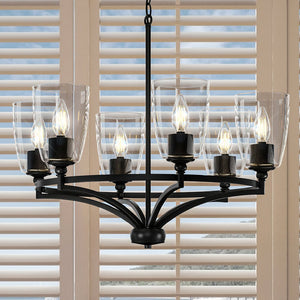 A unique and gorgeous lamp, the UHP4274 Traditional Chandelier from the Coronado Collection by Urban Ambiance features glass shades and hangs in front of a window.