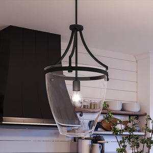 A beautiful luxury pendant lamp, finished in Midnight Black, hanging over a kitchen counter.