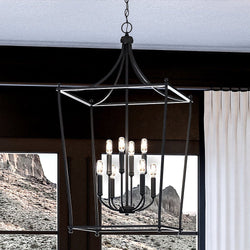 An UHP4281 Tranditional Chandelier 36''H x 20''W, Midnight Black Finish, Coronado Collection by Urban Ambiance hanging over a window in a living room.