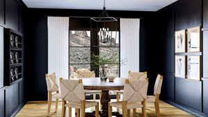 A beautiful dining room with a luxury lighting fixture.