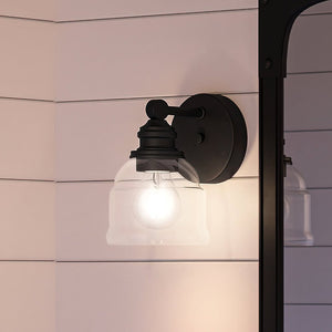 A unique, vintage wall sconce with a glass shade by Urban Ambiance.