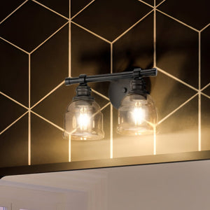 A beautiful bathroom with two luxury Urban Ambiance UHP4305 Vintage Bath Light 7.875''H x 13''W, Midnight Black Finish, Phoenix Collection fixtures and a mirror.