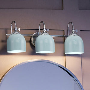 Three unique UHP4312 Vintage Bath Light 9''H x 24''W, Polished Chrome Finish fixtures hanging above a mirror.