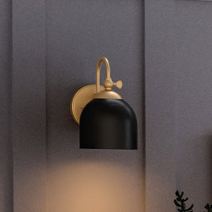 An Urban Ambiance luxury Vinatge Wall Sconce with Olde Brass Finish from the Jacksonville Collection, beautifully showcasing on a gray wall.