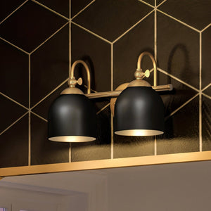 A gorgeous UHP4315 Vinatge Bath Light 9''H x 14.75''W, Olde Brass Finish lighting fixture in a bathroom with a beautiful tiled wall from