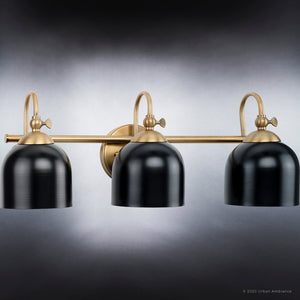 An Urban Ambiance UHP4316 Vintage Bath Light 9''H x 24''W, Olde Brass Finish from the Jacksonville Collection with unique black shades.
