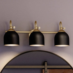 An Urban Ambiance bathroom vanity with three UHP4316 Vintage Bath Lights 9''H x 24''W, Olde Brass Finish, Jacksonville Collection and a mirror, featuring luxury lighting fixtures