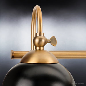 A beautiful Urban Ambiance brass lamp with a black ball on top.