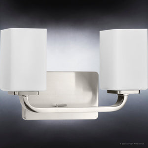 Two unique UHP4321 Contemporary Bath Light fixtures with white shades on a dark background.