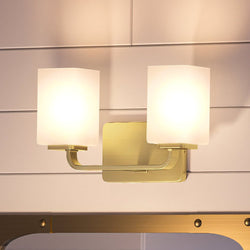 A bathroom with two unique UHP4325 Contemporary Bath Light 8.5''H x 13.5''W, Satin Gold Finish, Louisville Collection lighting fixtures and a mirror