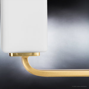 A stunning and luxurious Urban Ambiance UHP4326 Contemporary Bath Light 8.5''H x 23.5''W with a white shade and a brass base.
