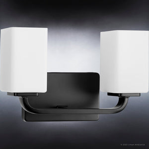 A beautiful lighting fixture from the Louisville Collection, featuring two unique square glass shades and a midnight black finish.
